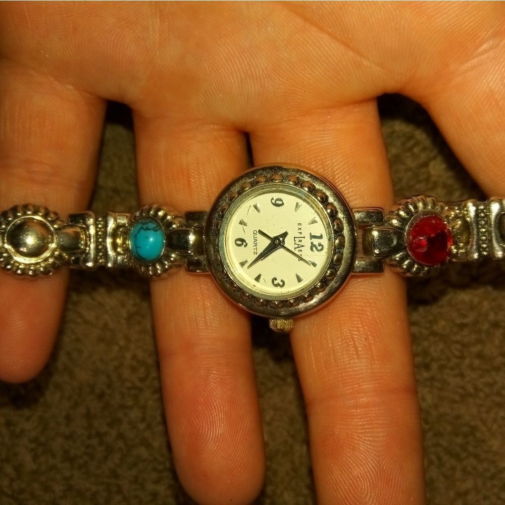 EXPLRAESS silver tone watch with a red and blue st